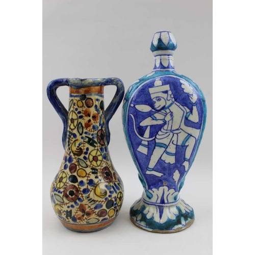 129 - An Iznik style vase, with figurative painted decoration, 24cm high, together with a glazed double ha... 