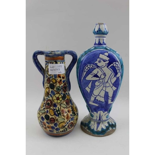 129 - An Iznik style vase, with figurative painted decoration, 24cm high, together with a glazed double ha... 