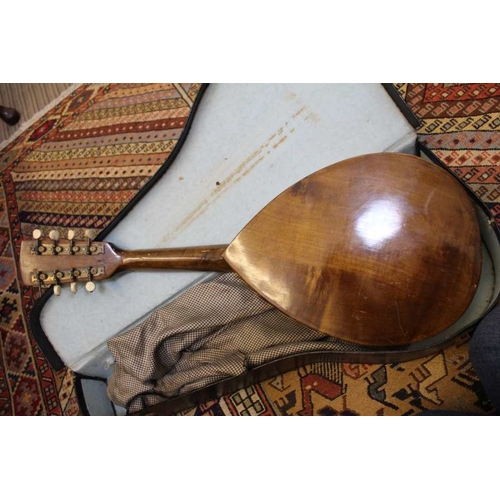 180 - A cased wooden mandolin of tear drop form