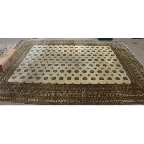 200 - A large room sized biscuit ground floor rug. With multi elephants foot decorated central field withi... 