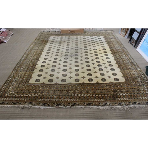 200 - A large room sized biscuit ground floor rug. With multi elephants foot decorated central field withi... 