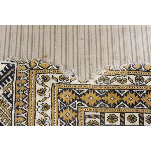 200 - A large room sized biscuit ground floor rug. With multi elephants foot decorated central field withi... 