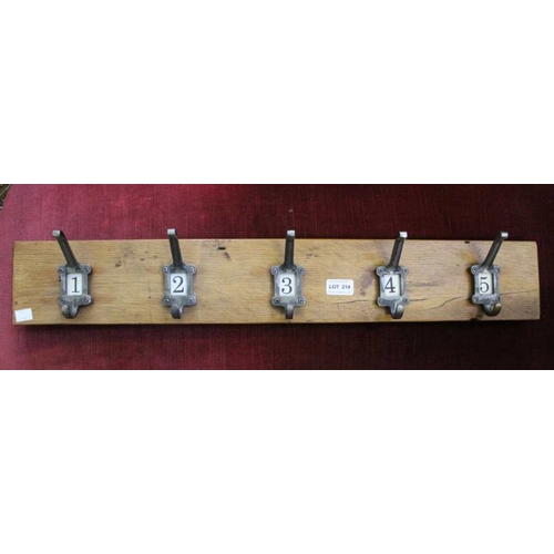 214 - A set of five numbered hat and coat hooks