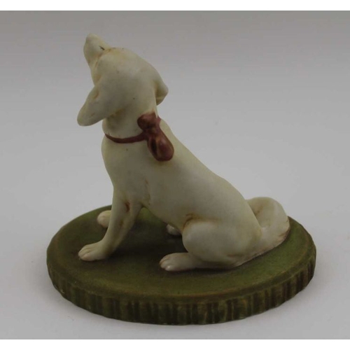 37 - A Royal Dux porcelain seated dog, sporting a pink ribbon, upon a green base, bears factory triangle ... 