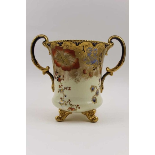 47 - A Royal Crown Derby two-handled bone china tankard hand painted and gilded decoration on a cream gro... 