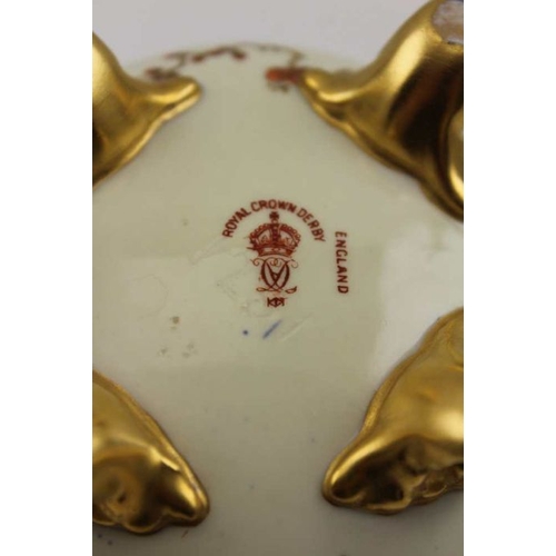 47 - A Royal Crown Derby two-handled bone china tankard hand painted and gilded decoration on a cream gro... 