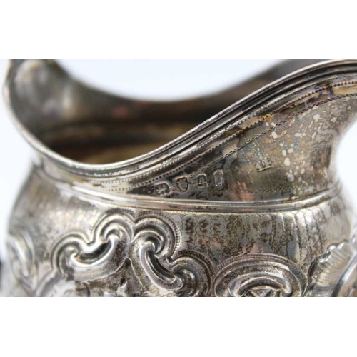 5 - Alexander Field, a George III silver milk jug, floral embossed decoration, engraved crest London 179... 