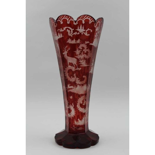 51 - A late 19th century Bohemian ruby flashed tapering glass vase, with stag decoration, on petal shape ... 