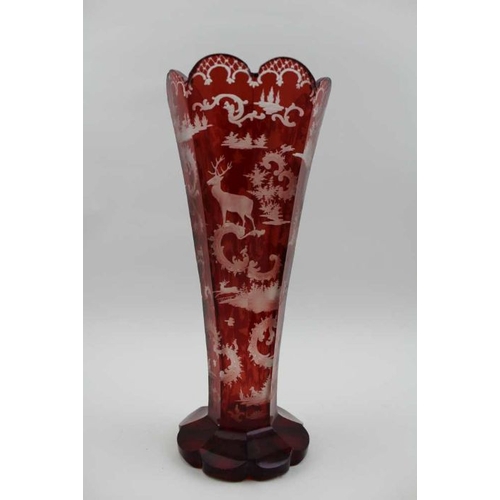 51 - A late 19th century Bohemian ruby flashed tapering glass vase, with stag decoration, on petal shape ... 