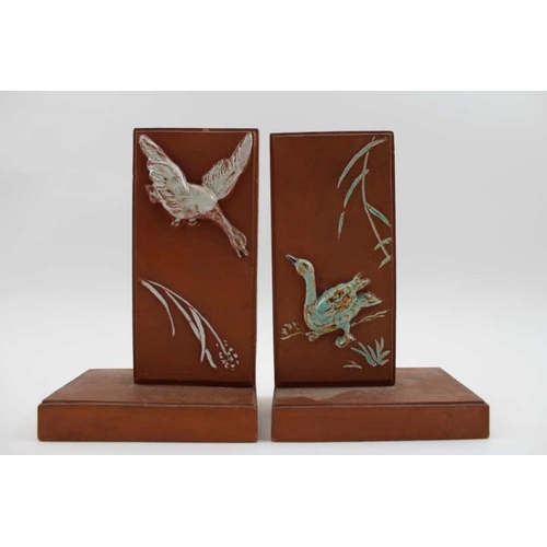 53 - A pair of terracotta bookends, with moulded and glazed geese decoration, 16cm high