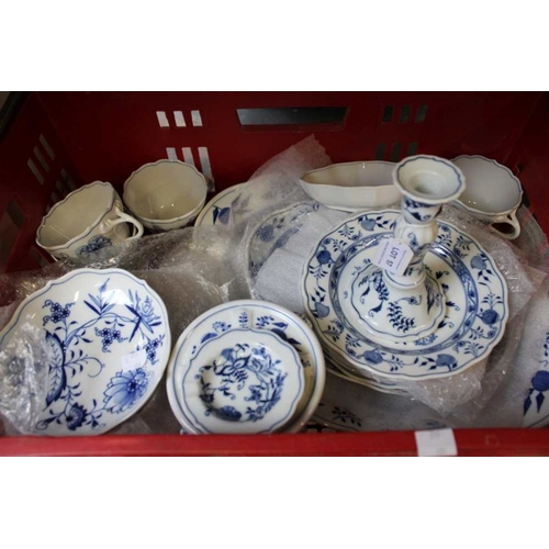 57 - A collection of Meissen blue onion pattern table ceramics, includes; plates, cups, candlestick, nigh... 