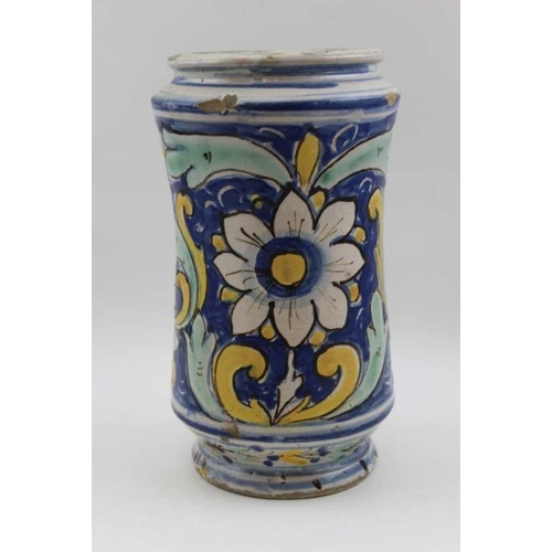 60 - A majolica wet drug jar, hand painted floral, and architectural panel, 23cm high / There are a few c... 