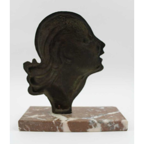 74 - An Art Deco ornament, formed as a cast metal profile of a young woman, inscribed 