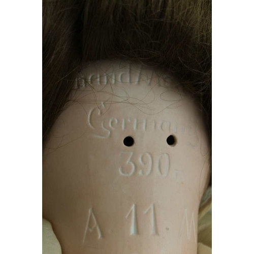 78 - An Armand Marseille, bisque head doll, with composition body, dressed. Inscribed to the back of the ... 