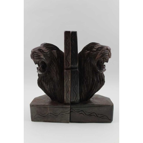 87 - A pair of carved wood bookends, lion mask decoration, 23cm high