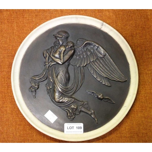 109 - A decorative roundel depicts and angel carrying children, 26cm diameter