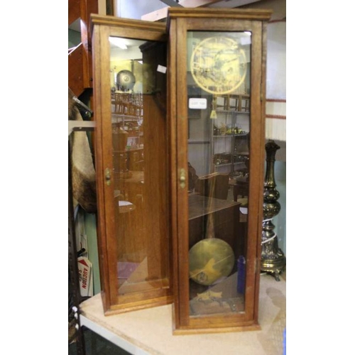 133 - Two clocks, within wooden cases (some parts in white tub)