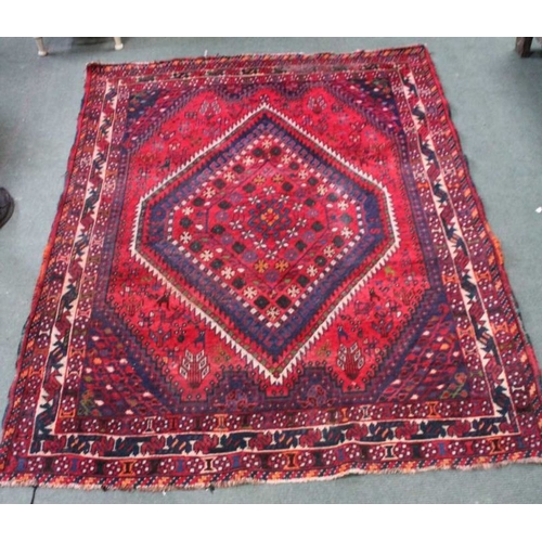 187 - A woven woolen geometric patterned floor carpet having central diamond design. 210 x 160 cm