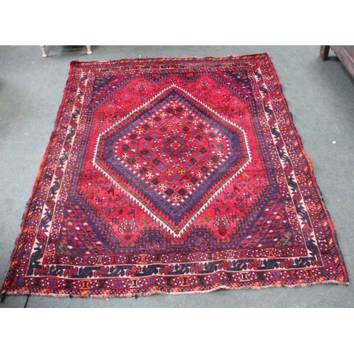 187 - A woven woolen geometric patterned floor carpet having central diamond design. 210 x 160 cm