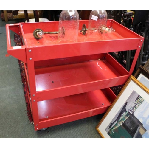 188 - A three tier red finished steel trolley.