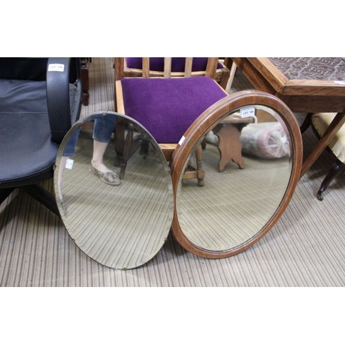 19 - Two oval bevel plate wall mirrors, one oak framed