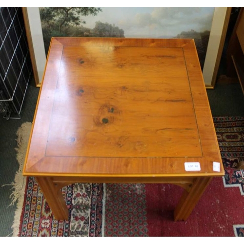 80 - A yew wood veneer coffee table, and a framed colour print after Krusemann