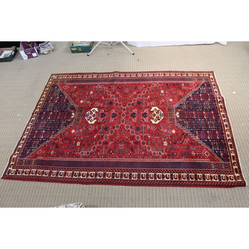 267 - A Persian Shiraz woven woollen carpet, busy blue and red central field 2.95m x 2.10m