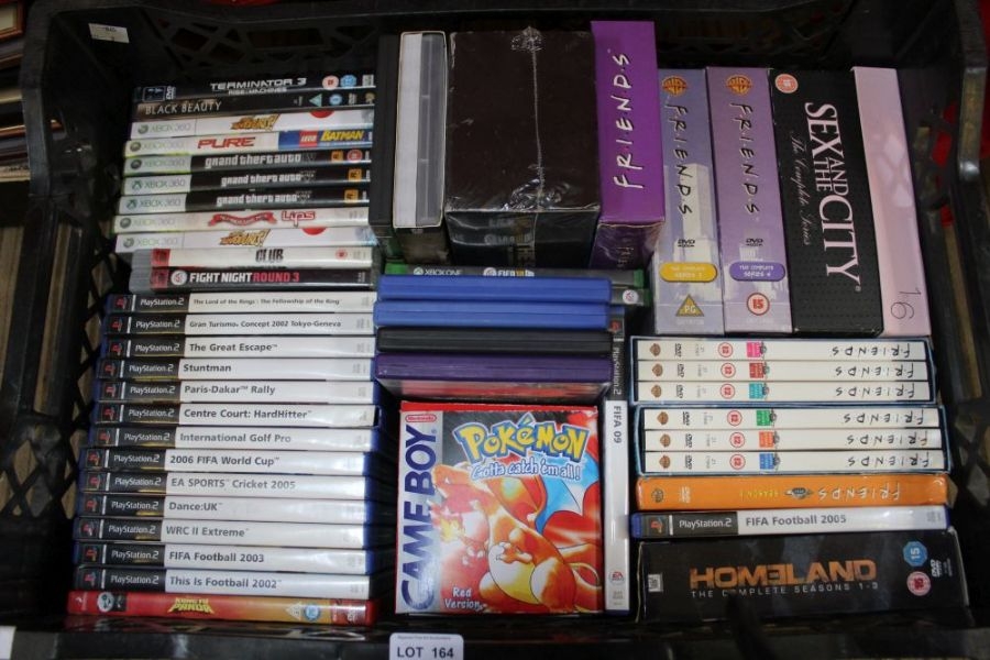 A box of videos, DVDs, and PS2 games to include a boxed Gameboy, Pokemon red version.