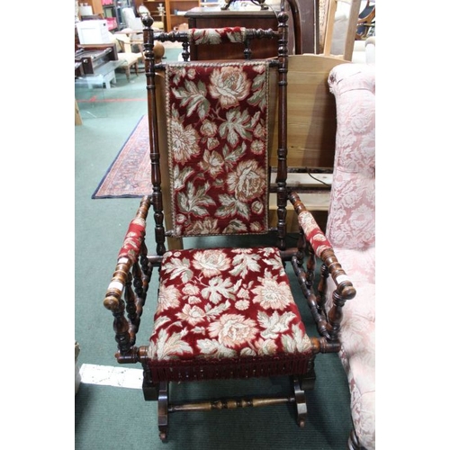 126 - An American turn wood frame rocking chair with upholstered seat and back.