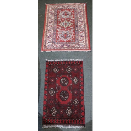 185 - Two geometric hearth rugs.