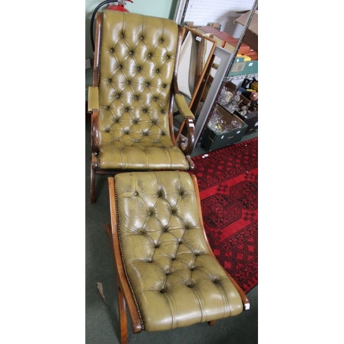 241 - A green button backed leather armchair with matching foot stool.