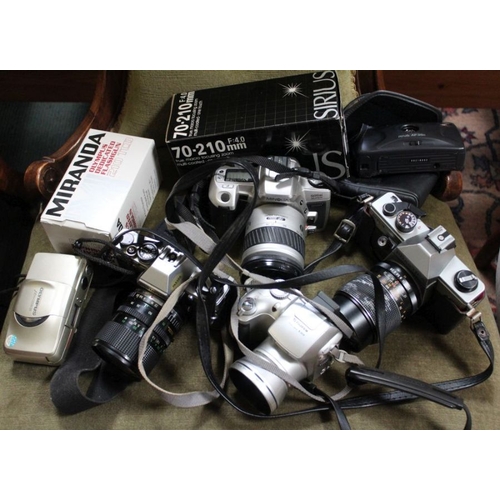 6 - An assortment of cameras, binoculars, lenses