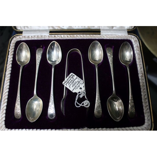 98 - A cased set of silver coffee spoons with sugar nips. A silver condiment spoon and a silver napkin ho... 