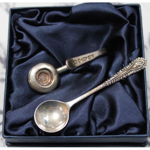 98 - A cased set of silver coffee spoons with sugar nips. A silver condiment spoon and a silver napkin ho... 