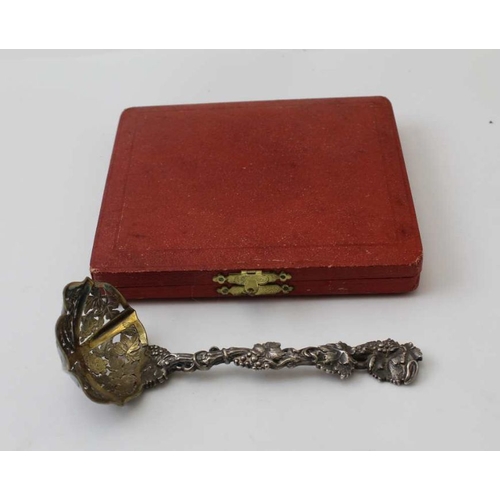 18 - Francis Higgins ll, a Victorian silver sifting ladle, fruiting vine cast handle, gilded bowl, London... 