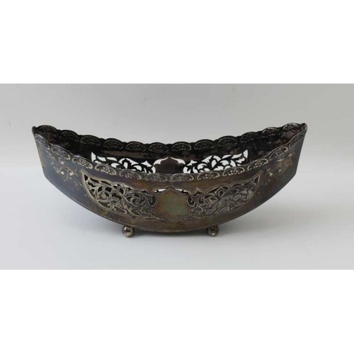 2 - William Aitkin, an Edwardian silver basket of boat form, pierced decoration, raised on four ball fee... 