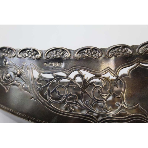 2 - William Aitkin, an Edwardian silver basket of boat form, pierced decoration, raised on four ball fee... 