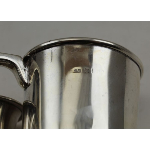 20 - I.S. Greenberg & co, a silver christening mug, Birmingham 1913, together with a larger silver christ... 