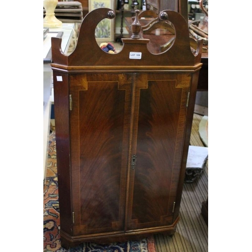 201 - A reproduction Georgian design mahogany hanging corner cupboard, with key