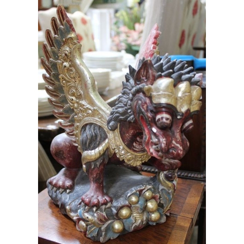 203 - A Balinese carved and painted wood dragon