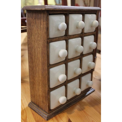 205 - A spice rack with porcelain drawers.