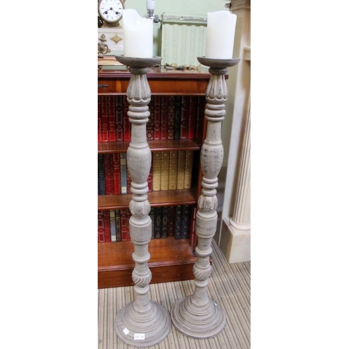 224 - A pair of modern wooden floor standing candle-sticks, 97.5cm high