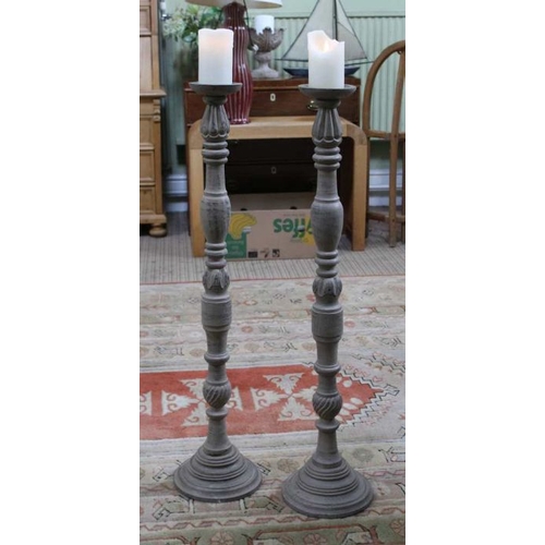 224 - A pair of modern wooden floor standing candle-sticks, 97.5cm high