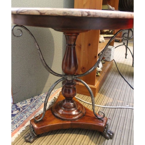 229 - A marble topped table with turned column & scrolling metal supports, with applied cast metal claw fe... 