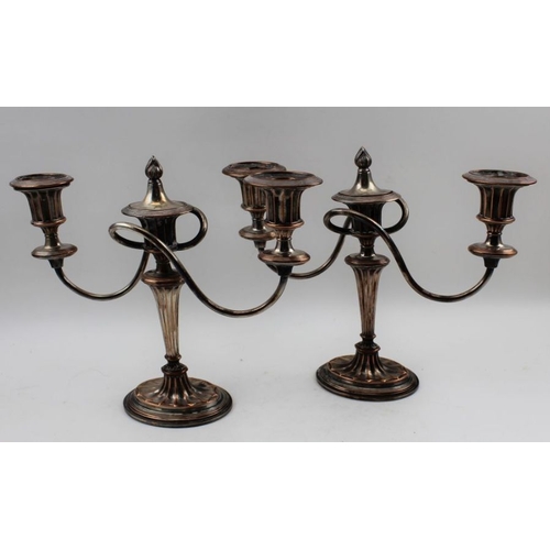 23 - A pair of Old Sheffield plate table candelabra, Adam twin branch design, with extinguisher's, on ova... 