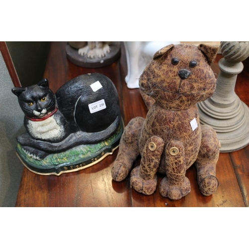 236 - A pair of door stops in the form of cats. One cast iron painted, the other a brown leather version.