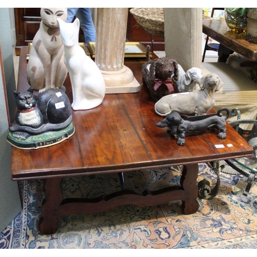 237 - An imported hardwood low coffee table in a Spanish stylevwith cast iron stretcher, 50cm x 148cm x 97... 