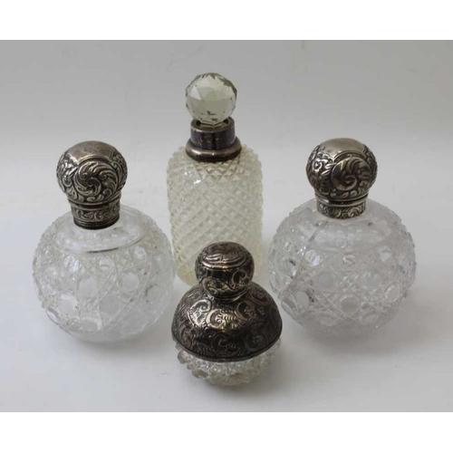 24 - A pair of Victorian, silver mounted cut glass scent bottles, the covers by John Grinsell and sons, B... 