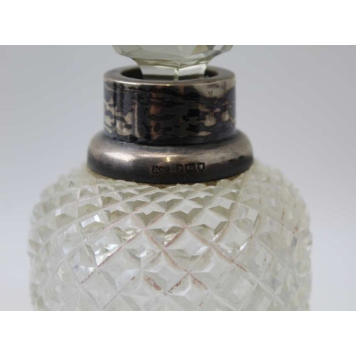 24 - A pair of Victorian, silver mounted cut glass scent bottles, the covers by John Grinsell and sons, B... 