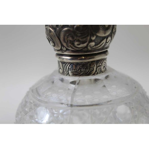 24 - A pair of Victorian, silver mounted cut glass scent bottles, the covers by John Grinsell and sons, B... 